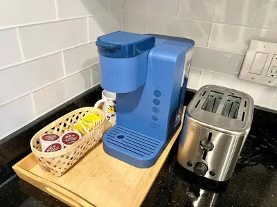 a blue coffee maker sitting on a counter next to a basket at 403 Luxury and Comfy King bed in Central city of phily in Philadelphia