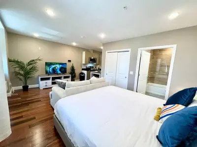 a bedroom with a large white bed and a couch at 403 Luxury and Comfy King bed in Central city of phily in Philadelphia