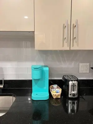 a blue coffee maker on a counter in a kitchen at 406 Luxury KING BED in central city of Philad in Philadelphia