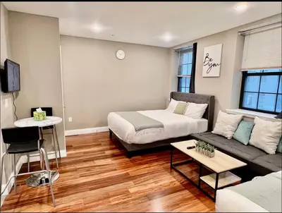 a living room with a bed and a couch at 406 Luxury KING BED in central city of Philad in Philadelphia