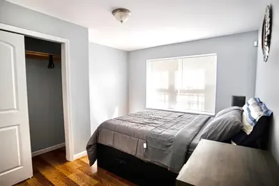 a bedroom with a bed and a window at Lovely Loft in Newark Minutes from NYC, EWR & American Dream Mall in Newark