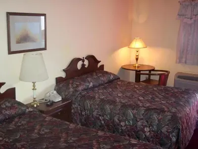 a hotel room with two beds and a table with a lamp at Grannys Motel Frackville in Frackville