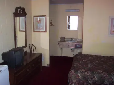 a hotel room with a bed and a sink at Grannys Motel Frackville in Frackville
