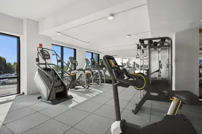 a gym with treadmills and elliptical machines at One Grove in Jersey City in Jersey City
