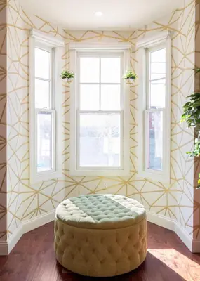 a room with a ottoman in a room with windows at Your Perch at University City in Philadelphia