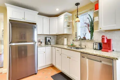 a kitchen with white cabinets and a stainless steel refrigerator at Your Perch at University City in Philadelphia