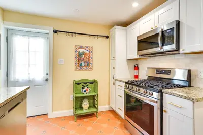 a kitchen with white cabinets and a stove at Your Perch at University City in Philadelphia