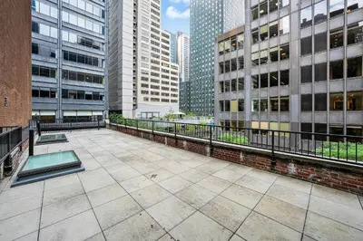 an empty courtyard in a city with tall buildings at Landmarked NYC Townhome - Sleeps 10 -Group-Friendly in New York
