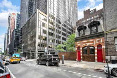 a busy city street with cars parked on the street at Landmarked NYC Townhome - Sleeps 10 -Group-Friendly in New York