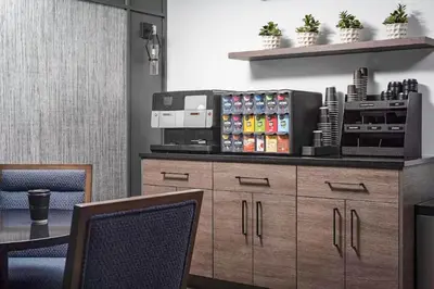 a kitchen with a wooden cabinet with drinks on it at Blueground Murray Hill gym lounge wd NYC-1565 in New York