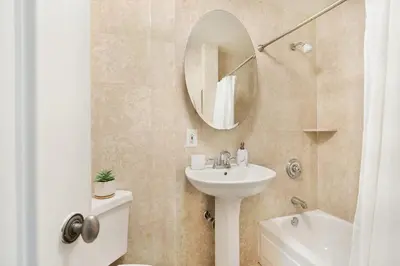 a bathroom with a sink and a toilet and a mirror at 73-308 New 1BR 1Bth UWS Doorman Gym in New York