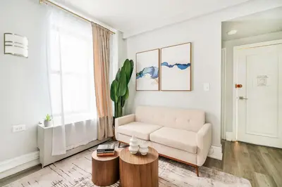 a living room with a couch and a table at 73-308 New 1BR 1Bth UWS Doorman Gym in New York