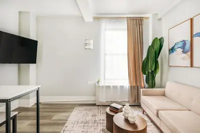 a living room with a couch and a table at 73-308 New 1BR 1Bth UWS Doorman Gym in New York