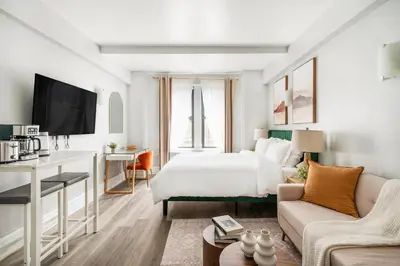 a hotel room with a bed and a couch at 73-518 Newly Reno Studio UWS Doorman Gym Laundry in New York