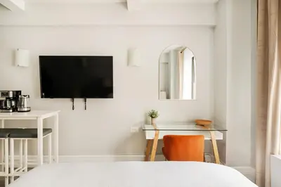 a bedroom with a tv and a desk and a bed at 73-518 Newly Reno Studio UWS Doorman Gym Laundry in New York