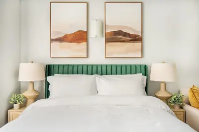 a bedroom with a green bed with three paintings on the wall at 73-518 Newly Reno Studio UWS Doorman Gym Laundry in New York