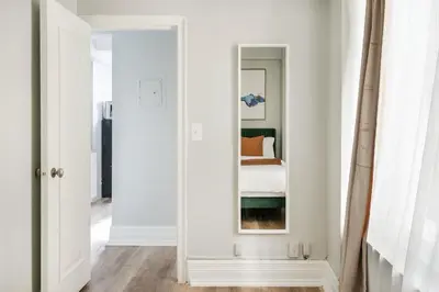 a hallway with a mirror and a bed in a room at 73-608 New 1BR 1Bth UWS Doorman Gym in New York