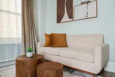 a living room with a couch and a table at 73-608 New 1BR 1Bth UWS Doorman Gym in New York