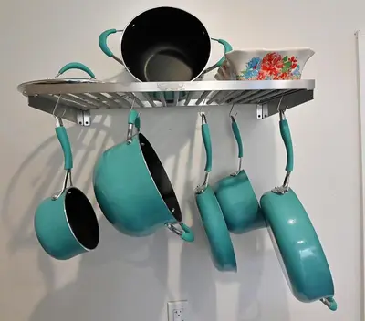 a rack with pots and pans hanging from a wall at Cozy Sanctuary in Jersey City