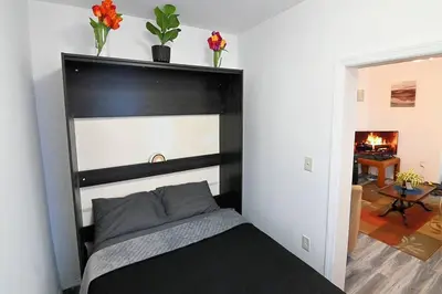 a bed with a black headboard in a room at Hidden Gem-1Bedroom with Plenty Free Street Parking in Communipaw