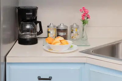 a bowl of fruit on a counter next to a coffee maker at 3 Bedroom Gem! King, Full & Twin Beds, Sauna with Free Parking plus more in Jersey City