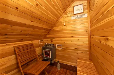 a room with a stove in a wooden cabin at 3 Bedroom Gem! King, Full & Twin Beds, Sauna with Free Parking plus more in Jersey City