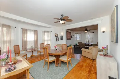 a dining room and living room with a table and chairs at 3 Bedroom Gem! King, Full & Twin Beds, Sauna with Free Parking plus more in Jersey City