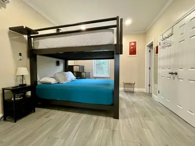 a bedroom with a bunk bed with a blue bed at New York City Apartment Near Free Ferry Boat! in Stapleton
