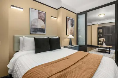a bedroom with a large bed with black pillows at Stunning Apt in The Heart of New York City GYM in New York