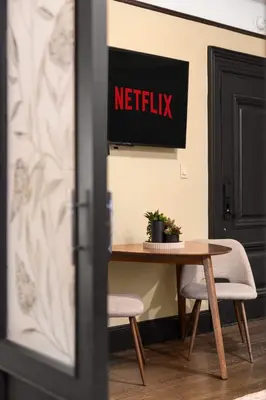 a table with two chairs and a netflix sign on the wall at Stunning Apt in The Heart of New York City GYM in New York