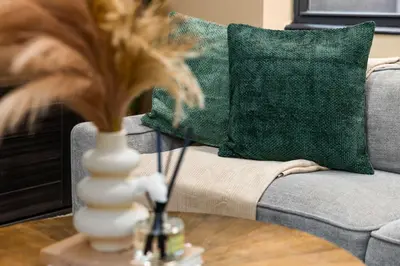a vase on a table in front of a couch at Stunning Apt in The Heart of New York City GYM in New York