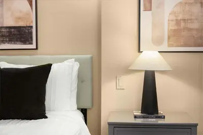 a bedroom with a bed and a lamp on a nightstand at Stunning Apt in The Heart of New York City GYM in New York