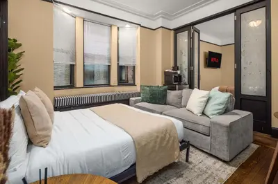 a hotel room with a bed and a couch at Stunning Apt in The Heart of New York City GYM in New York