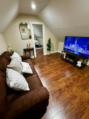 a living room with a couch and a flat screen tv at Private Cozy Apartment - Only 5 min Away from Newark Airport and 30 min to NYC in Elizabeth