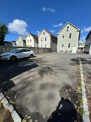 a car parked in a parking lot with houses at Private Cozy Apartment - Only 5 min Away from Newark Airport and 30 min to NYC in Elizabeth