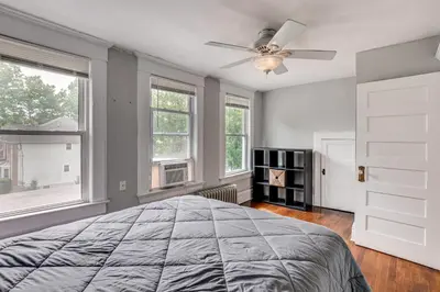 a bedroom with a bed and a ceiling fan at Madison Home Walk to Main Street! in Madison