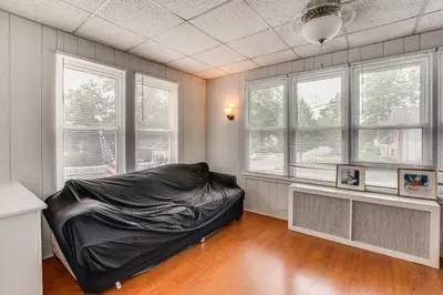 a bedroom with a bed in a room with windows at Madison Home Walk to Main Street! in Madison