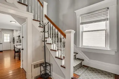 a white staircase in a home with a window at Madison Home Walk to Main Street! in Madison
