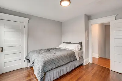 a white bedroom with a bed and a closet at Madison Home Walk to Main Street! in Madison