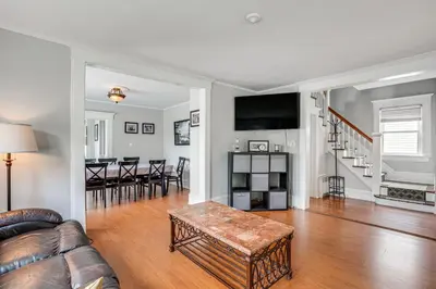 a living room with a couch and a table at Madison Home Walk to Main Street! in Madison
