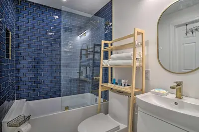 a bathroom with a tub and a toilet and a sink at Live Loftily at University City in Philadelphia