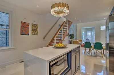 a kitchen with a bowl of fruit on a counter at Live Loftily at University City in Philadelphia