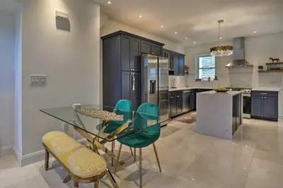 a kitchen with a glass table and green chairs at Live Loftily at University City in Philadelphia