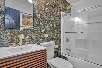 a bathroom with a toilet and a sink and a shower at La Casita at Creekview in Gouldsboro