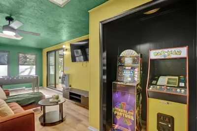 a living room with a video game machine in a room at La Casita at Creekview in Gouldsboro