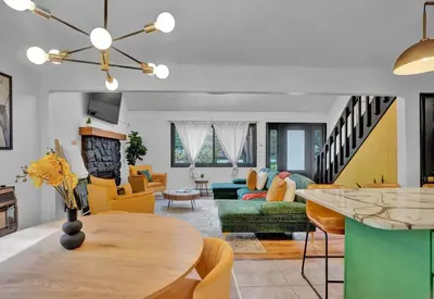 a living room with a table and a couch at La Casita at Creekview in Gouldsboro