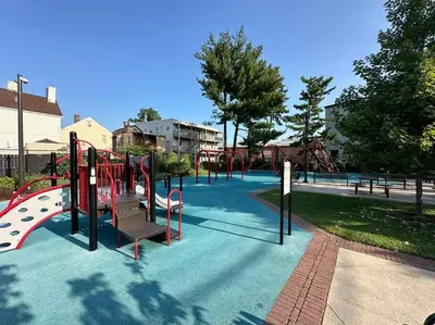 a playground with a slide in a park at Comfy NJ 2BR Close to Airport, Dream Mall & NYC in East Newark