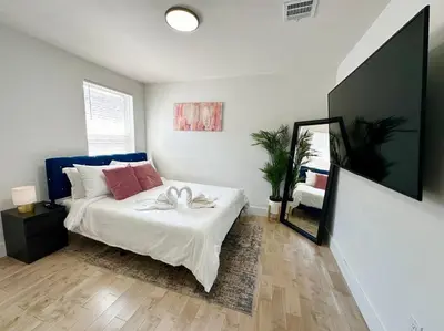 a bedroom with a bed with two swans on it at Comfy NJ 2BR Close to Airport, Dream Mall & NYC in East Newark