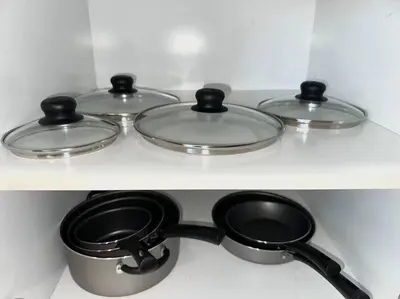 three pots and pans sitting on a shelf at Comfy NJ 2BR Close to Airport, Dream Mall & NYC in East Newark