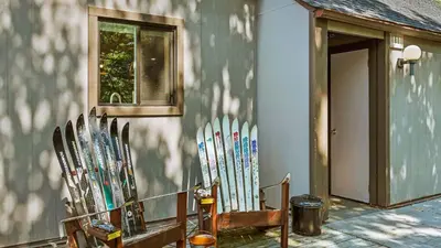 a bunch of skis are lined up against a wall at Slopeside Escape by AvantStay Walk to Ski Lifts Arcade Games Shuffleboard in Tannersville
